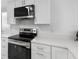 Close up of modern white kitchen with stainless steel appliances at 4716 Eldorado Dr, Tampa, FL 33615