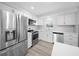 Well-lit kitchen featuring stainless steel appliances, light countertops, and white cabinetry at 4725 Cove Cir # 202, St Petersburg, FL 33708