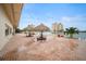 Outdoor patio featuring picturesque waterfront views, picnic tables, and tiki umbrellas at 4725 Cove Cir # 202, St Petersburg, FL 33708