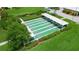 Aerial view of a meticulously maintained shuffleboard court surrounded by lush landscaping at 4725 Cove Cir # 202, St Petersburg, FL 33708