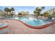 Outdoor swimming pool with ample seating, lounge chairs, and tropical landscaping at 4725 Cove Cir # 202, St Petersburg, FL 33708