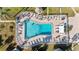 Aerial view of a community pool with lounge chairs and tropical landscaping at 5246 81St N St # 6, St Petersburg, FL 33709