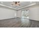 Empty bedroom featuring tray ceilings, recessed lighting, wood-look floors and neutral paint at 5885 114Th N Ter, Pinellas Park, FL 33782