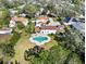 Stunning aerial view of a home featuring a unique clover-shaped pool, lush landscaping and beautiful tile roofs at 6010 17Th S Ave, Gulfport, FL 33707