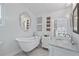 Classic bathroom with a standalone tub, marble countertop sink, and vintage-inspired decor at 6010 17Th S Ave, Gulfport, FL 33707