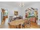 Charming dining area featuring hardwood floors, a unique chandelier, and access to the kitchen and living room at 6010 17Th S Ave, Gulfport, FL 33707