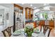 Elegant kitchen featuring stainless steel refrigerator, wood cabinetry, and arched doorway at 6010 17Th S Ave, Gulfport, FL 33707