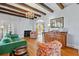 Elegant living room showcasing hardwood floors, ceiling beams, a fireplace, a green sofa, and classic decor at 6010 17Th S Ave, Gulfport, FL 33707