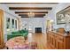 Bright living room with hardwood floors, decorative ceiling beams, fireplace, and large windows providing natural light at 6010 17Th S Ave, Gulfport, FL 33707