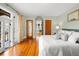 Sunlit main bedroom featuring hardwood floors, French doors to a balcony, and a serene color palette at 6010 17Th S Ave, Gulfport, FL 33707