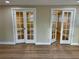 Bright Living Room with wood flooring featuring french doors and allowing natural light to fill the space at 7281 Channelside N Ln, Pinellas Park, FL 33781