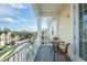 Outdoor balcony with seating and a view of the residential neighborhood with palms at 7611 34Th W Ave # 303, Bradenton, FL 34209