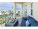 Outdoor balcony seating area with blue cushioned sofa and great views of the community at 7611 34Th W Ave # 303, Bradenton, FL 34209