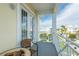 Balcony with outdoor seating and a view of the white rooftops, palms, and blue skies at 7611 34Th W Ave # 303, Bradenton, FL 34209