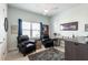 This bedroom features neutral walls, two leather chairs and sports memorabilia for a unique feel at 7611 34Th W Ave # 303, Bradenton, FL 34209