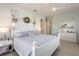 Serene bedroom with light blue bedding, decorative windows, and a ceiling fan at 7611 34Th W Ave # 303, Bradenton, FL 34209