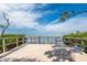 Wooden dock with railings overlooking calm waters and lush mangroves under a blue sky at 7611 34Th W Ave # 303, Bradenton, FL 34209