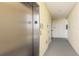 Hallway view with elevator, neutral walls, and doorways, providing a clean and functional space at 7611 34Th W Ave # 303, Bradenton, FL 34209