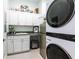 Laundry room featuring white cabinets, stainless steel appliances, sink, and countertop space at 7611 34Th W Ave # 303, Bradenton, FL 34209