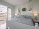 This main bedroom has light blue walls, a white bed frame, and a private balcony at 7611 34Th W Ave # 303, Bradenton, FL 34209