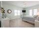 A serene bedroom featuring gray toned walls, a ceiling fan, and an outdoor balcony at 7611 34Th W Ave # 303, Bradenton, FL 34209