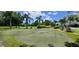 Community putting green is surrounded by mature trees and tropical landscaping at 7611 34Th W Ave # 303, Bradenton, FL 34209