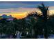 Beautiful sunset view over the water with palm trees and resort buildings at 7611 34Th W Ave # 303, Bradenton, FL 34209