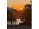 Picturesque community sunset view showcasing waterfront living among palm trees at 7611 34Th W Ave # 303, Bradenton, FL 34209