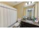 Neutral bathroom features granite vanity with a sink and bathtub with shower at 780 Spring Flowers Trl, Brandon, FL 33511