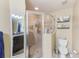 Modern bathroom features glass shower, toilet, vanity with sink and shelving at 780 Spring Flowers Trl, Brandon, FL 33511