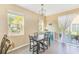 Bright dining area with natural light, a sliding glass door, modern light fixture, and seating for four at 780 Spring Flowers Trl, Brandon, FL 33511