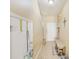 Bright hallway featuring neutral paint, tile flooring, coat closet, and seating for removing footwear at 780 Spring Flowers Trl, Brandon, FL 33511