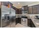 Spacious kitchen featuring dark cabinets, stainless steel appliances, and granite countertops at 780 Spring Flowers Trl, Brandon, FL 33511