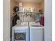 Clean laundry room with modern washer and dryer and shelving at 780 Spring Flowers Trl, Brandon, FL 33511