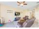 Inviting living room featuring wood-look floors, a ceiling fan, and ample seating space at 780 Spring Flowers Trl, Brandon, FL 33511