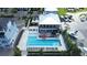 Aerial view of a community pool, boats, and a two story clubhouse at 923 Seagrape Dr, Ruskin, FL 33570