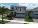 Charming stucco home with a tile roof, a paved driveway, and a well-maintained lawn at 923 Seagrape Dr, Ruskin, FL 33570