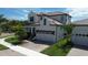 Beautiful two-story house featuring a two-car garage, well-manicured lawn, and lush landscaping at 923 Seagrape Dr, Ruskin, FL 33570