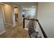 Open hallway on second story with carpeted floors and views of the living area and laundry at 923 Seagrape Dr, Ruskin, FL 33570