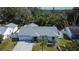 An aerial view of a single-story home boasting a well-manicured lawn and a charming neutral color scheme at 9693 58Th N St, Pinellas Park, FL 33782