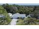 An aerial view of a beautiful single-story home with a well-maintained lawn and surrounding greenery at 9693 58Th N St, Pinellas Park, FL 33782