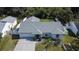 An aerial view showcases a single-story home with a well-kept roof, lawn, and paved driveway at 9693 58Th N St, Pinellas Park, FL 33782