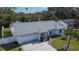 Aerial view of a single-story home featuring a well-maintained yard and a driveway leading to the garage at 9693 58Th N St, Pinellas Park, FL 33782