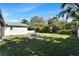 View of the backyard with patio firepit, lawn, and perimeter fence for relaxing or entertaining at 9693 58Th N St, Pinellas Park, FL 33782