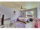 bedroom with light colored wood floors, ceiling fan and purple rug at 9693 58Th N St, Pinellas Park, FL 33782