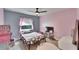 Colorful bedroom with a window, a bed, and laminate wood flooring at 9693 58Th N St, Pinellas Park, FL 33782