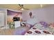 bedroom with light colored wood floors, dresser with television and purple rug at 9693 58Th N St, Pinellas Park, FL 33782