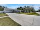 Wide driveway leading up to the house with manicured lawn and mature landscaping at 9693 58Th N St, Pinellas Park, FL 33782