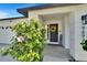 Front entrance with a welcoming wreath, welcome sign, and a flowering bush at 9693 58Th N St, Pinellas Park, FL 33782