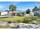 Inviting home with a well-kept lawn, complemented by a central palm tree, and a spacious driveway at 9693 58Th N St, Pinellas Park, FL 33782